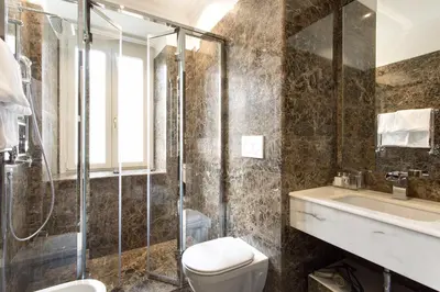 a bathroom with a shower and a toilet and a sink at Le case di Andrea - Roof Suite Rome in Rome