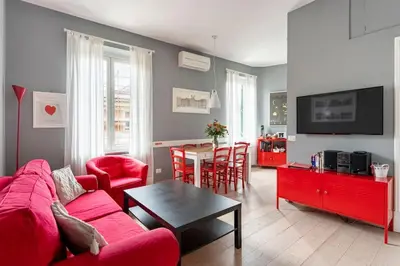 a living room with a red couch and a table at Walking to Trastevere di Marialaura Aragno in Rome