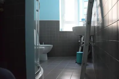 a bathroom with a toilet and a sink and a window at Walking to Trastevere di Marialaura Aragno in Rome