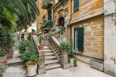 a set of stairs with potted plants in front of a building at Walking to Trastevere di Marialaura Aragno in Rome