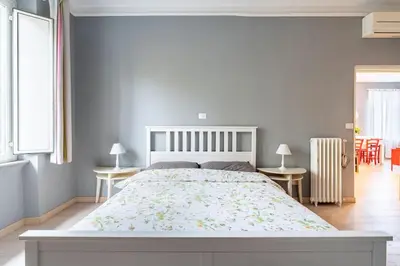a bedroom with a large bed and two tables at Walking to Trastevere di Marialaura Aragno in Rome