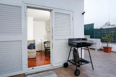 an open door to a balcony with a grill at Enjoy the Sunset on Your Vatican Terrace in Rome