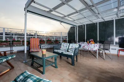 a patio with a table and chairs on a patio at Enjoy the Sunset on Your Vatican Terrace in Rome