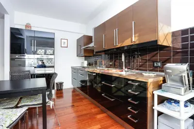a kitchen with wooden cabinets and a counter top at Enjoy the Sunset on Your Vatican Terrace in Rome