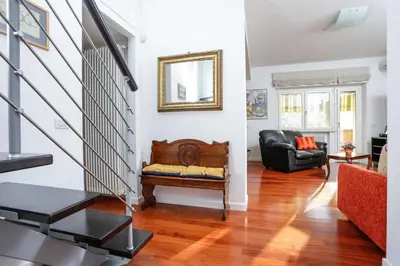 a living room with a staircase and a couch at Enjoy the Sunset on Your Vatican Terrace in Rome