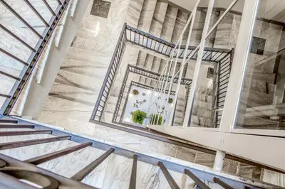 a staircase in a building with a large mirror at Gioberti Art Hotel in Rome