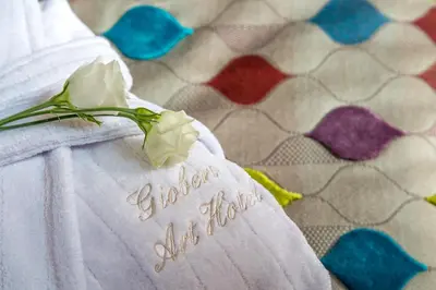 a white dress with a flower on it at Gioberti Art Hotel in Rome