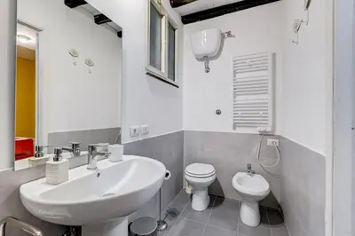 a white bathroom with a sink and a toilet at Trastevere Suite Just Renewed in Rome