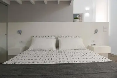 a bedroom with a large bed with two pillows at Castelfidardo Apartment in Rome