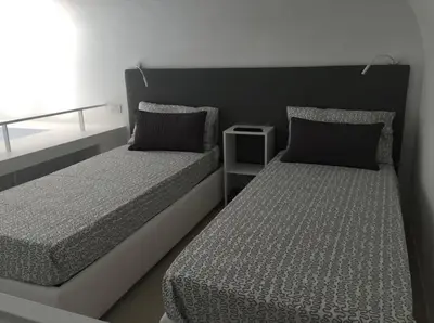 two beds sitting next to each other in a bedroom at Castelfidardo Apartment in Rome