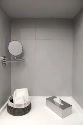 a bathroom with a mirror and a pile of towels at Castelfidardo Apartment in Rome