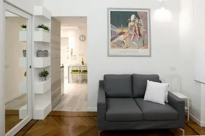 a living room with a couch and a picture on the wall at Castelfidardo Apartment in Rome