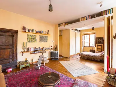a large living room with a bed and a tv at Apartment 'Colo' by Interhome in Rome