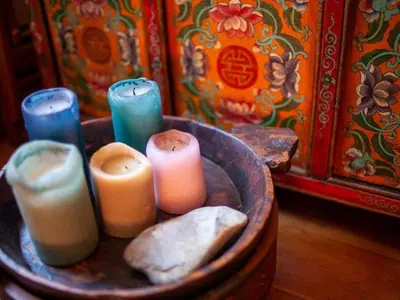 a group of candles in a wooden bowl at Apartment 'Colo' by Interhome in Rome