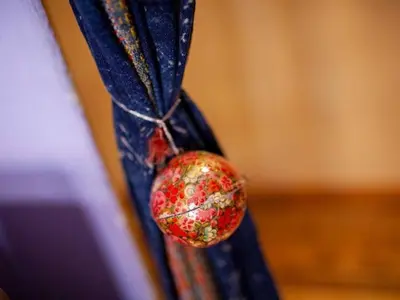 a red ornament hanging from a blue curtain at Apartment 'Colo' by Interhome in Rome
