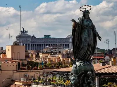 a statue of a woman standing in front of a city at Apartment Appartement mit Dachterrasse by Interhome in Rome