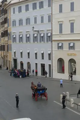 a horse drawn carriage in front of a building at Apartment Appartement mit Dachterrasse by Interhome in Rome