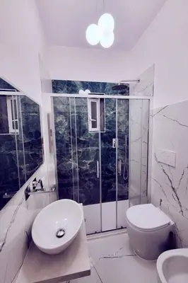 a white bathroom with a toilet and a sink at Apartment 'Rhome Sweet Rhome by Interhome in Rome