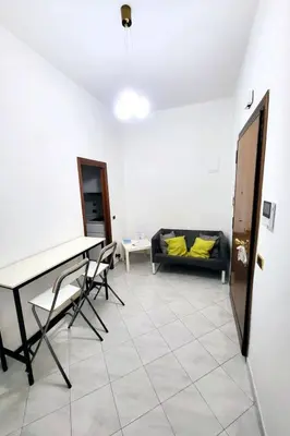 a living room with a couch and a table and chairs at Apartment 'Rhome Sweet Rhome by Interhome in Rome