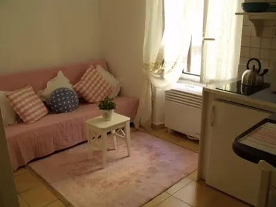 a living room with a pink couch and a table at Apartment in Trastevere im Herzen von Rom by Interhome in Rome