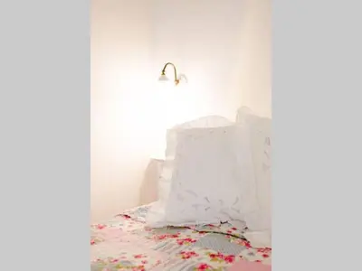 a white bedroom with a bed and a lamp at Apartment in Trastevere im Herzen von Rom by Interhome in Rome