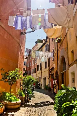 an alley with clothes drying on a clothes line at Apartment in Trastevere im Herzen von Rom by Interhome in Rome