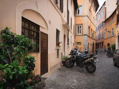 a motorcycle parked on a street next to a building at Apartment Charmantes- komfortables Studio im Herzen von Rom by Interhome in Rome