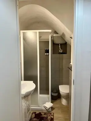 a small bathroom with a sink and a toilet at House&Colosseum in Rome