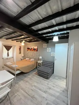 a bedroom with a bed and a couch in a room at House&Colosseum in Rome