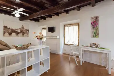 a living room with white furniture and a table at House&Colosseum in Rome