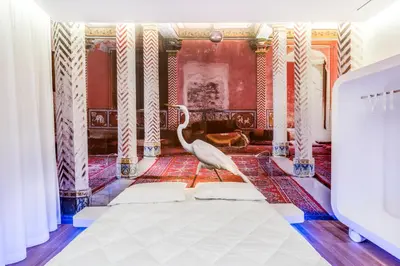 a living room with a white chair in a room at Trevi Elite Rome in Rome