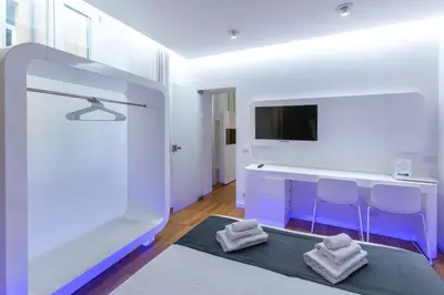 a room with a tv and two stools at Trevi Elite Rome in Rome