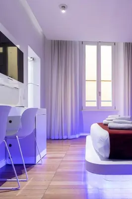 a bedroom with a bed and a desk with a computer at Trevi Elite Rome in Rome