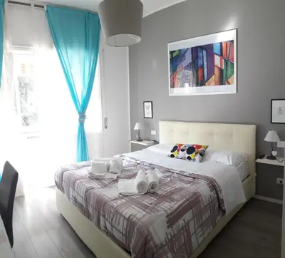 a bedroom with a large bed with blue curtains at Domus Raffaello in Rome