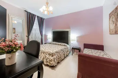 a hotel room with a bed and a couch at Ai 7 Scalini in Rome