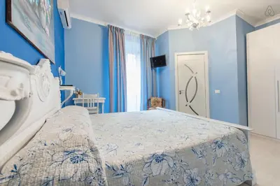 a bedroom with a bed with blue walls at Ai 7 Scalini in Rome