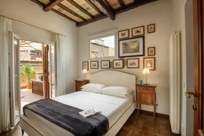 a bedroom with a large white bed and a window at The Right Place 4U Navona Luxury Rooms in Rome