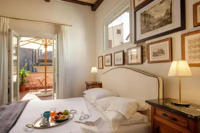 a bedroom with a bed with a plate of fruit on it at The Right Place 4U Navona Luxury Rooms in Rome