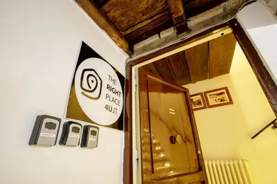 a sign on a wall with two cell phones on the wall at The Right Place 4U Navona Luxury Rooms in Rome