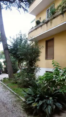 a building with a bunch of plants next to a street at Guest's Heaven in Rome