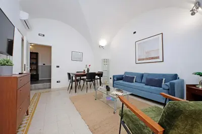 a living room with a blue couch and a table at Luxury Spagna Apartments in Rome
