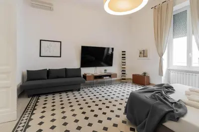 a living room with a couch and a tv at Luxury Spagna Apartments in Rome