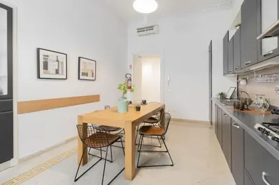 a kitchen with a wooden table and chairs at Luxury Spagna Apartments in Rome