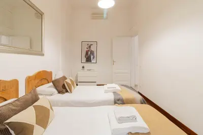two beds in a room with white walls at Luxury Spagna Apartments in Rome