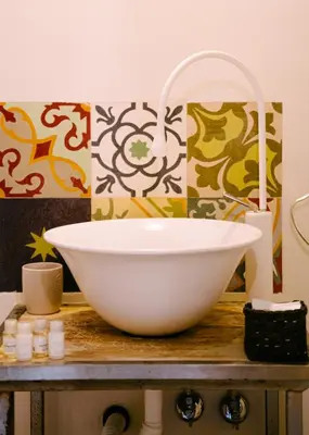 a bathroom with a white bowl sink on a counter at Terrazza Munira Trastevere in Rome
