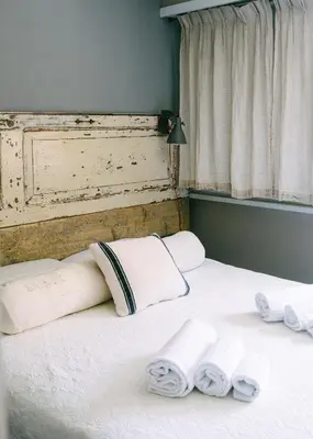 a bed with white pillows and towels on it at Terrazza Munira Trastevere in Rome