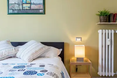 a bedroom with a bed and a white radiator at Rome To You- The Place to be&B in Rome