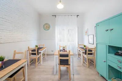 a room with tables and chairs and a clock on the wall at Rome To You- The Place to be&B in Rome