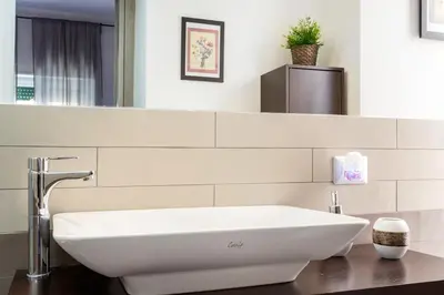 a bathroom with a white sink and a mirror at Rome To You- The Place to be&B in Rome