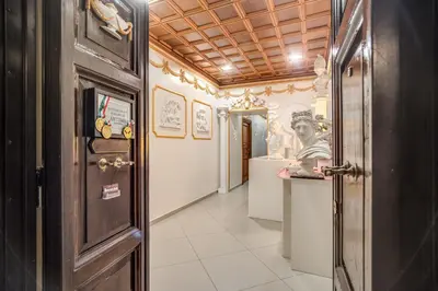 a hallway of a museum with a statue on the wall at Artemis in Rome